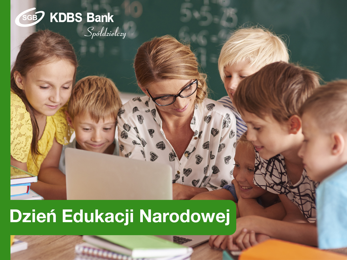 Nauczyciel siedzący przy biurku, a dookoła dzieci.